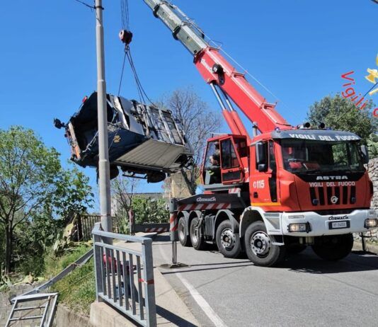 Probabile guasto al freno – Compattatore dei rifiuti in sosta travolge auto e finisce in un cortile privato
